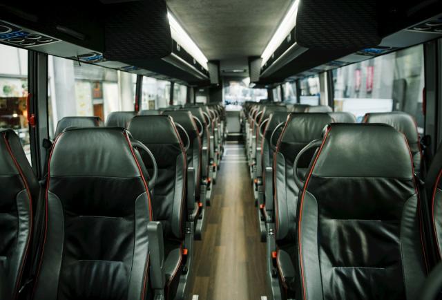 Rows of leather seats inside a Washington Deluxe coach