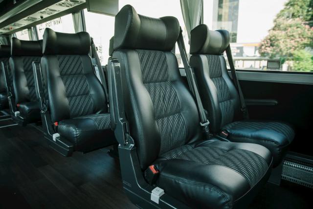 Leather captain's chairs with tables on an Elite coach